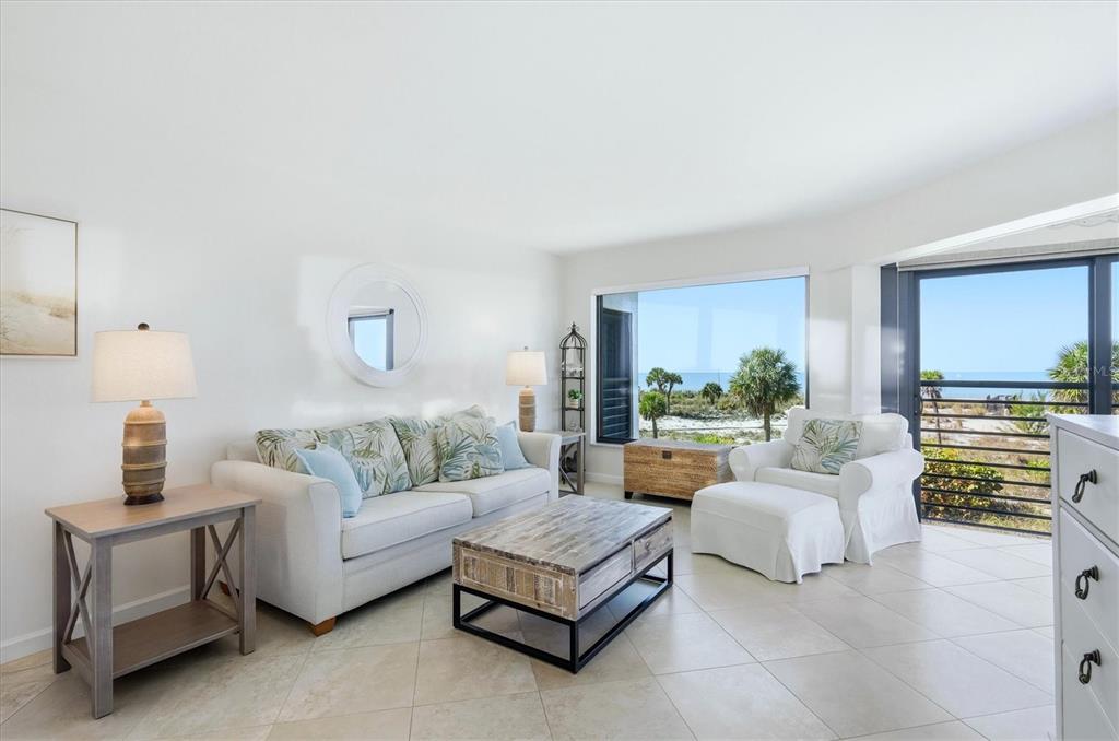 5000 Gasparilla Road, Unit BC205 Boca Grande, FL 33921 - Photo 3 of 50 a living room with furniture and a large window