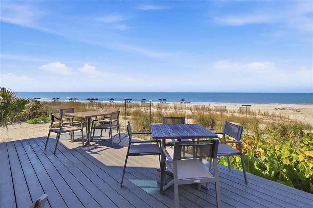 5000 Gasparilla Road, Unit BC205 Boca Grande, FL 33921 - Photo 35 of 50 a view of a chairs and table on wooden deck with lake view