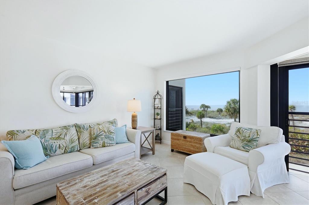 5000 Gasparilla Road, Unit BC205 Boca Grande, FL 33921 - Photo 5 of 50 a living room with furniture and a large window