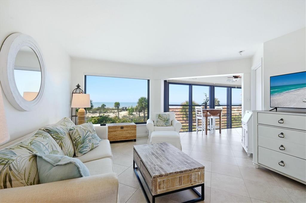 5000 Gasparilla Road, Unit BC205 Boca Grande, FL 33921 - Photo 9 of 50 a living room with furniture and a flat screen tv