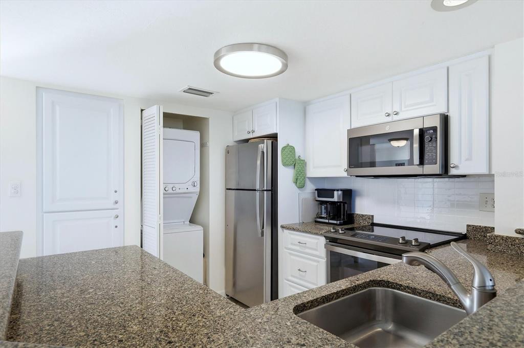 5000 Gasparilla Road, Unit BC205 Boca Grande, FL 33921 - Photo 10 of 50 a kitchen with a refrigerator sink and microwave