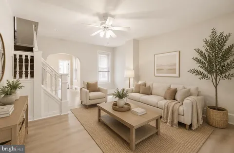 a living room with furniture and a chandelier