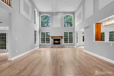 a large kitchen with stainless steel appliances granite countertop a sink a stove and a wooden floors