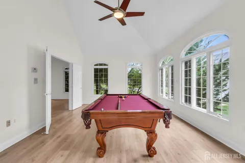 a view of an empty room with wooden floor and closet
