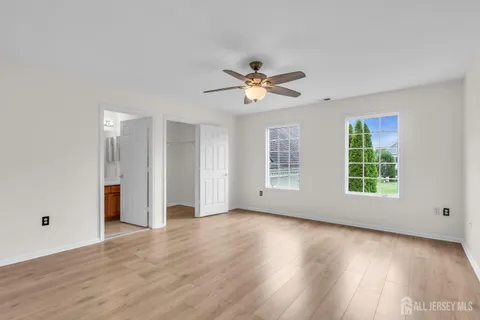 a view of a big house with a big yard and large trees