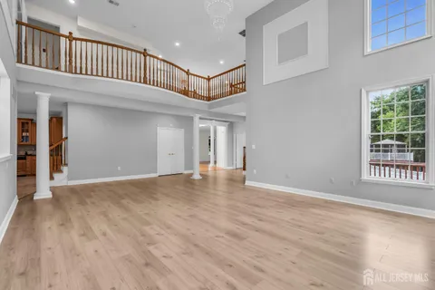 a view of a room with wooden floor and a window