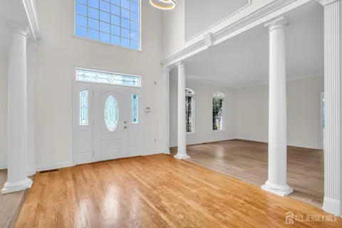 an empty room with wooden floor and a window
