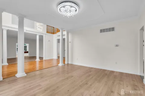 a view of an empty room with a window and fireplace