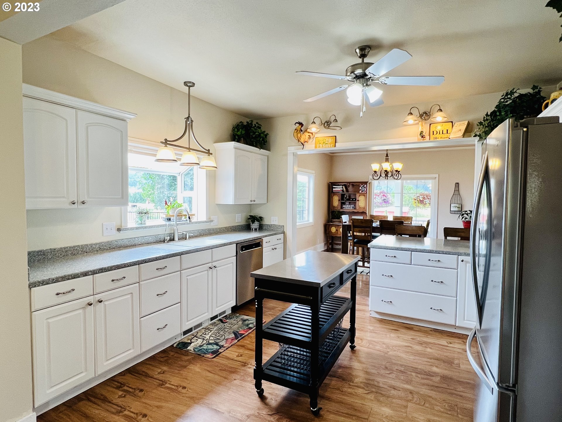 5393 Nonpareil Road Sutherlin, OR 97479 - Photo 11 of 42 a kitchen with white cabinets and appliances