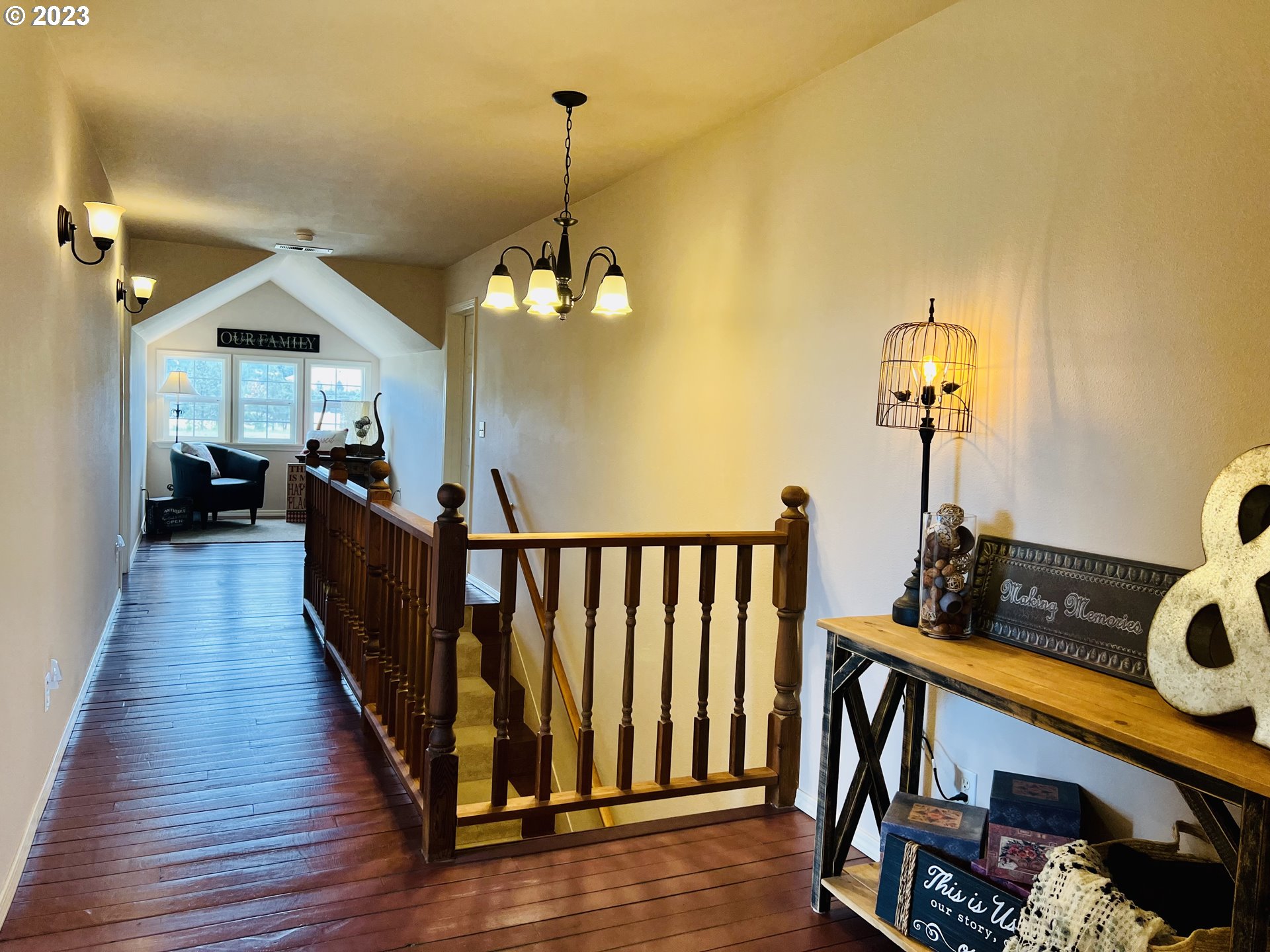 5393 Nonpareil Road Sutherlin, OR 97479 - Photo 22 of 42 a view of a hallway with couches lamp and chandelier