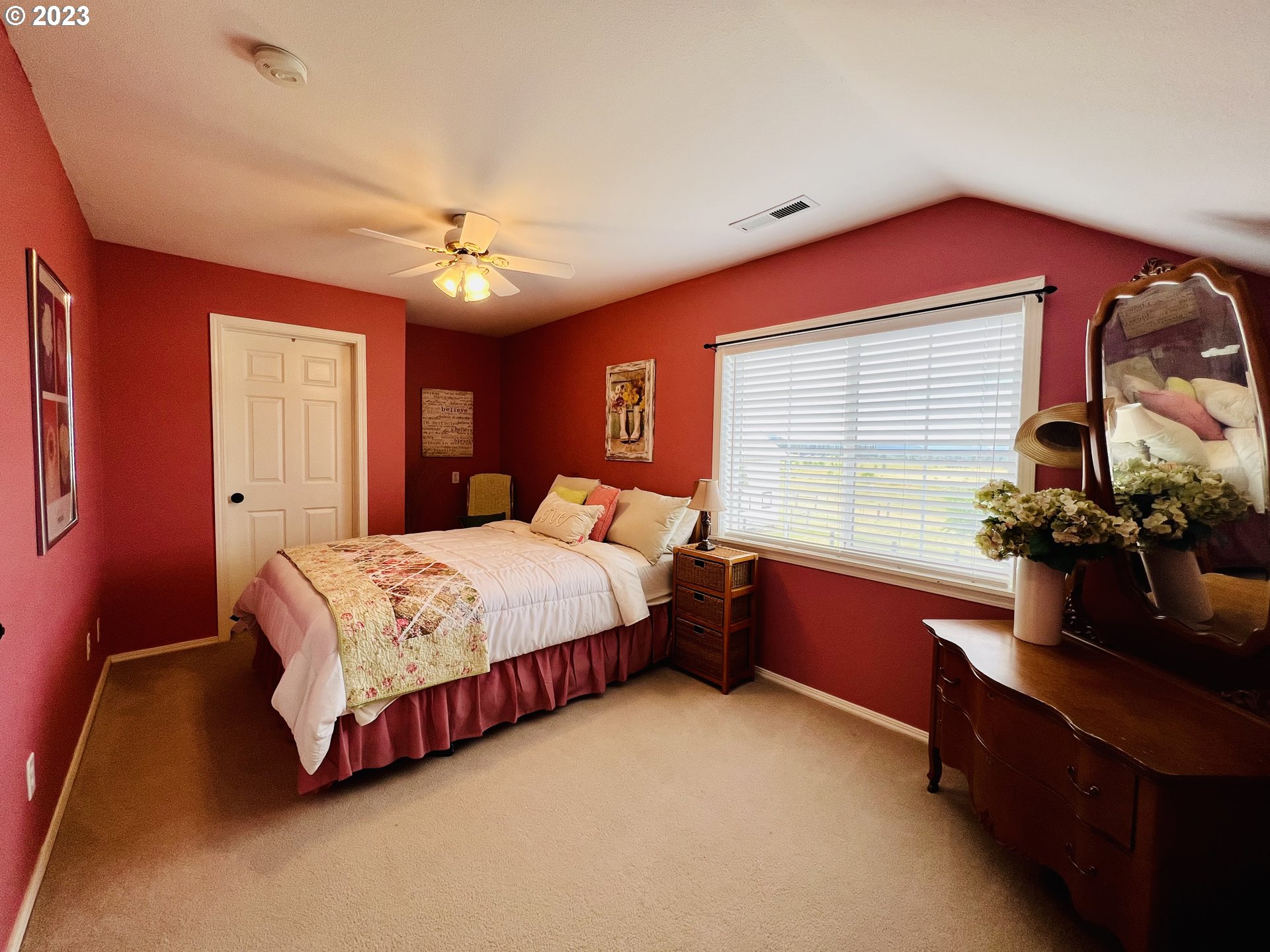 5393 Nonpareil Road Sutherlin, OR 97479 - Photo 23 of 42 a bedroom with a bed chandelier and a window