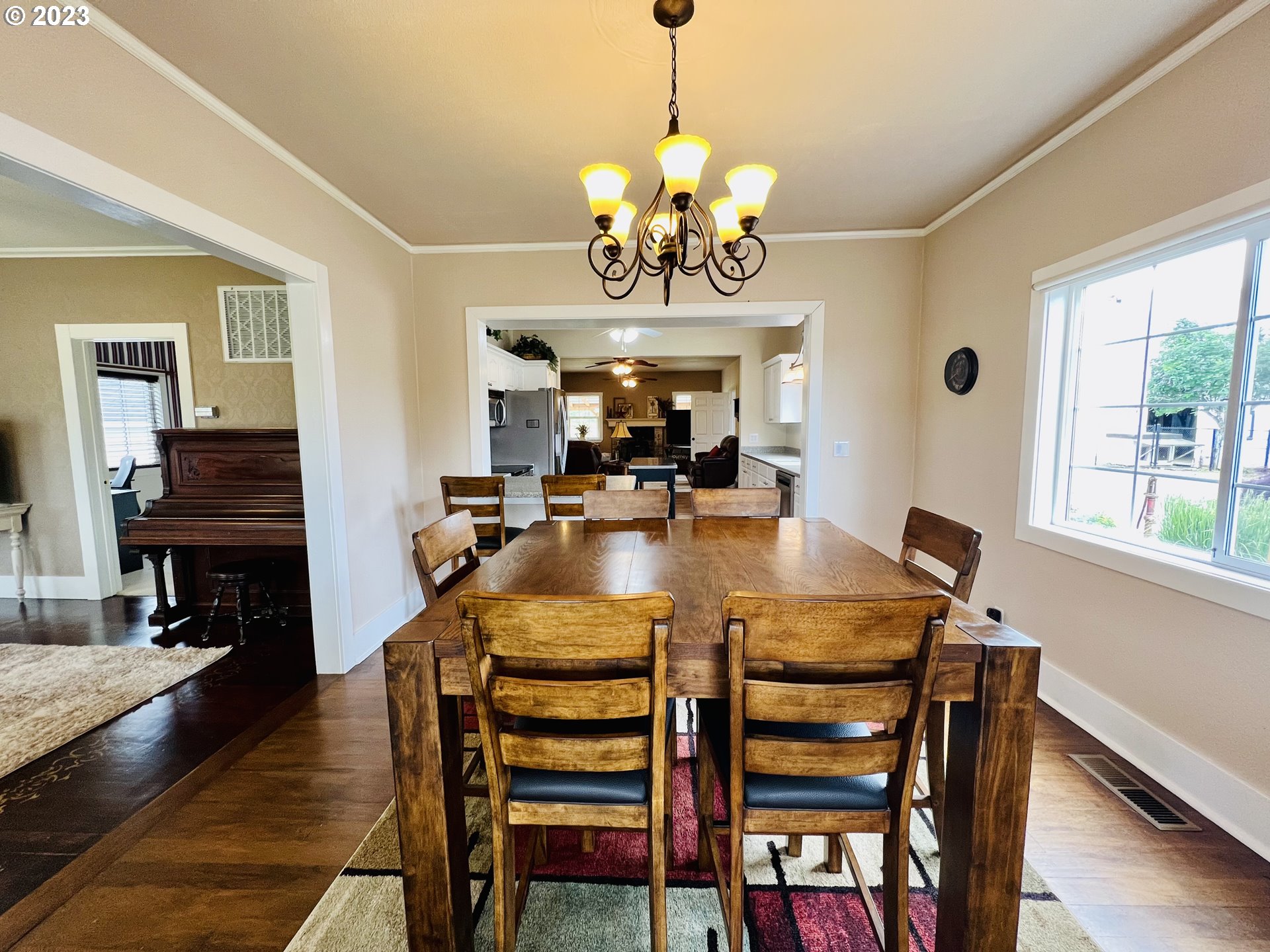 5393 Nonpareil Road Sutherlin, OR 97479 - Photo 8 of 42 a view of a dining room with furniture wooden floor and chandelier