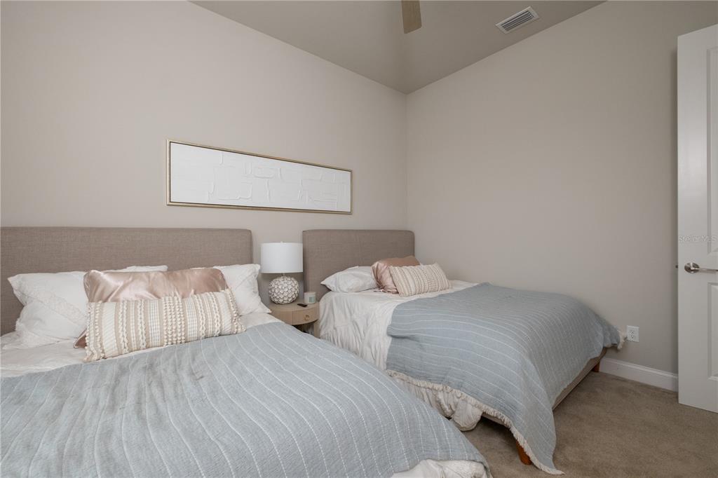 3350 Southwest 120th Terrace Gainesville, FL 32608 - Photo 19 of 32 a bedroom with two beds and painting on the wall