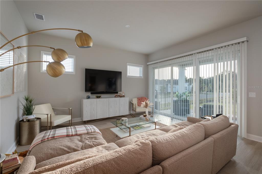 3350 Southwest 120th Terrace Gainesville, FL 32608 - Photo 7 of 32 a living room with furniture and a flat screen tv