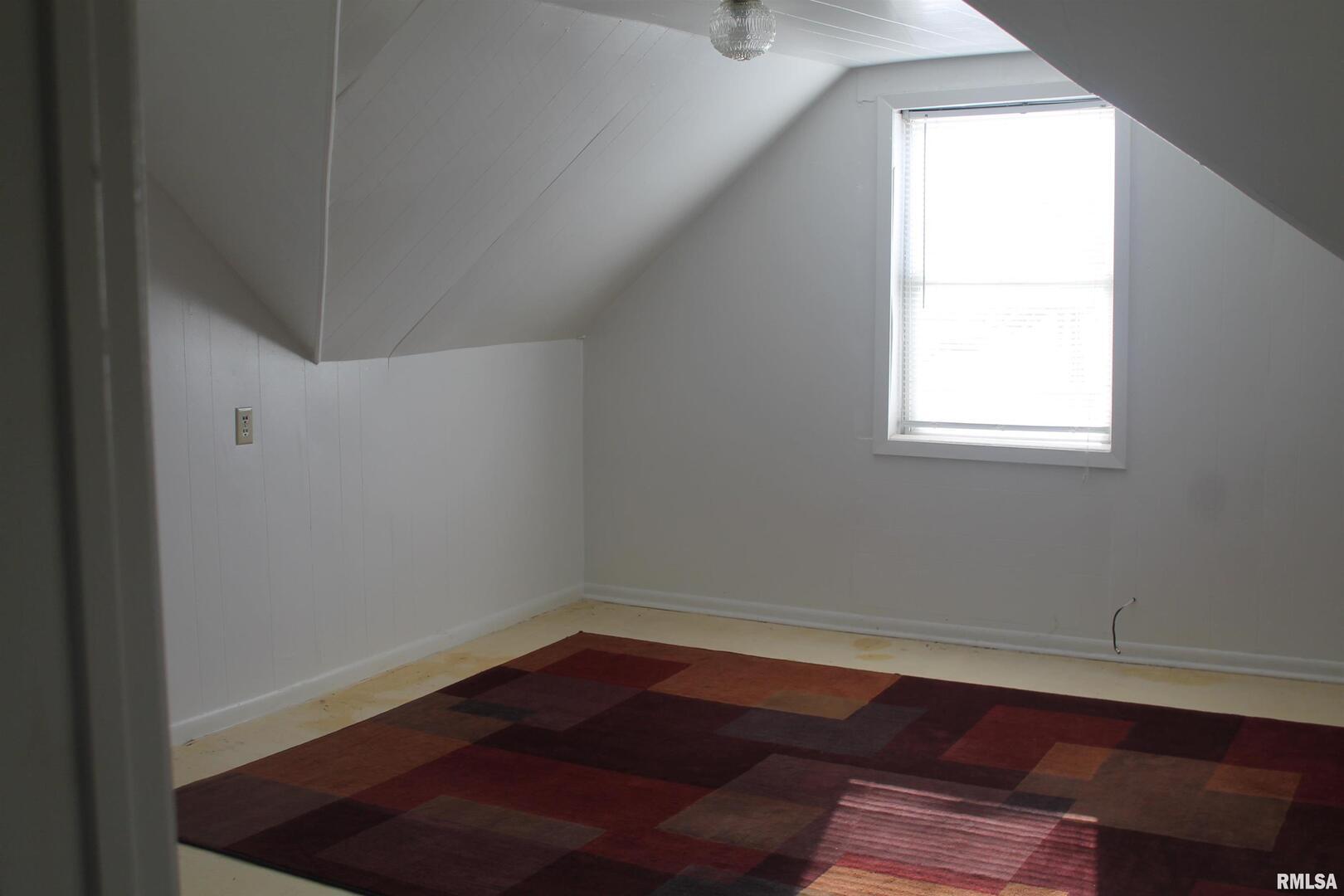 701 West Cherry Street, Unit 1 Carbondale, IL 62901 - Photo 8 of 9 a room with wooden floor and window