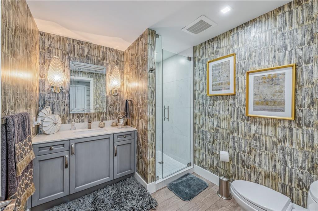 13915 Old Coast Road, Unit 2004 Naples, FL 34110 - Photo 12 of 28 Bedroom featuring access to exterior, beamed ceiling, and a tray ceiling