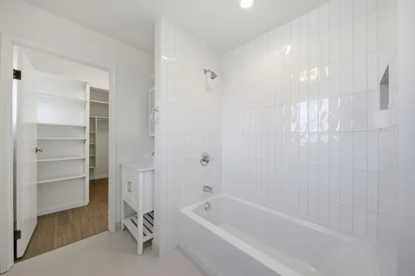 a bathroom with a bathtub and a shower