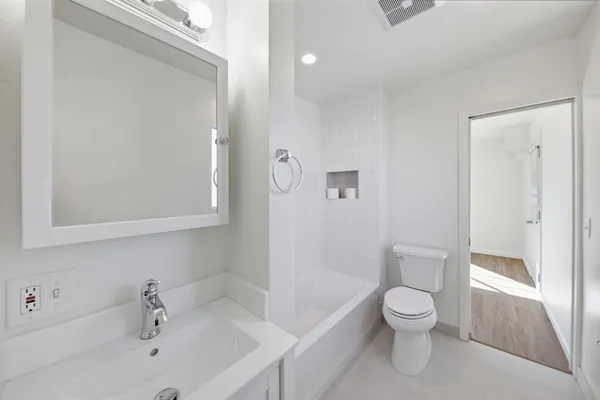 a white toilet sitting next to a bathroom sink