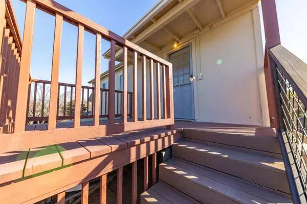 a view of porch with wooden stairs