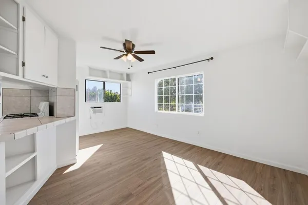 a view of a kitchen with wooden floor and windows