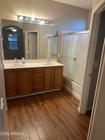 a bathroom with a sink mirror and a shower