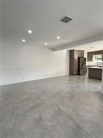 an empty room with furniture and windows