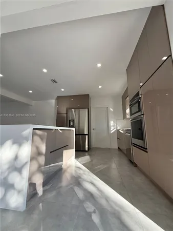 a view of kitchen with furniture and a refrigerator