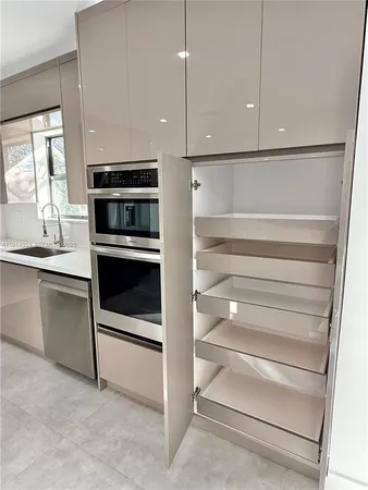 a kitchen with cabinets and stainless steel appliances