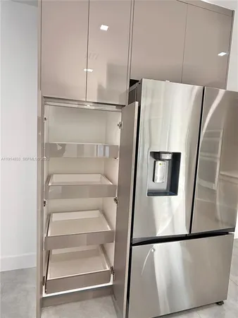 a kitchen with a refrigerator a sink and cabinets