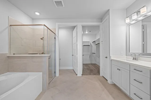 a bathroom with a tub a sink and mirrors