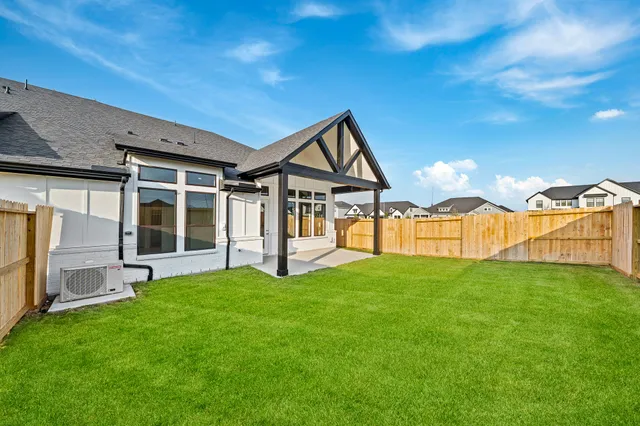 a view of a house with a yard and porch