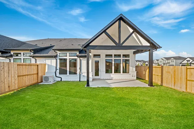 a view of a house with a yard and porch