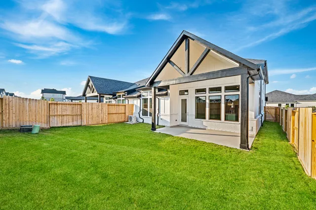 a view of a house with backyard and porch