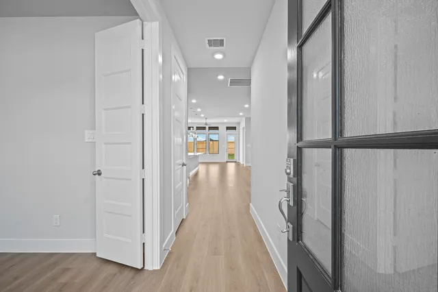 a view of hallway with wooden floor and staircase