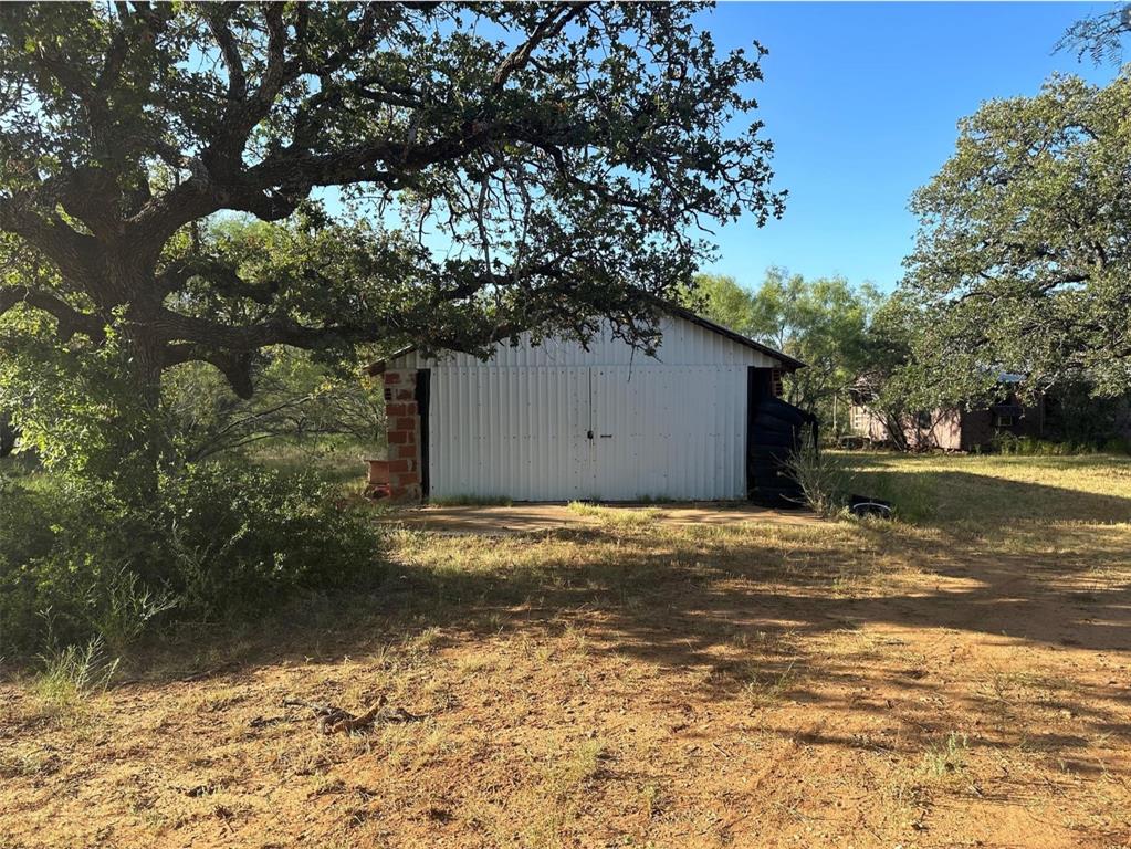 331 County Road Bangs, TX 76823 - Photo 30 of 33 a house with trees in front of it
