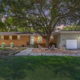 a view of back yard of the house with outdoor seating and green space