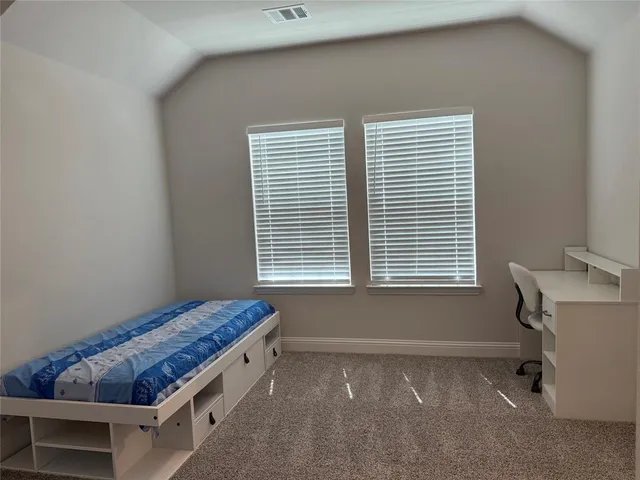 a room with a bed and a window