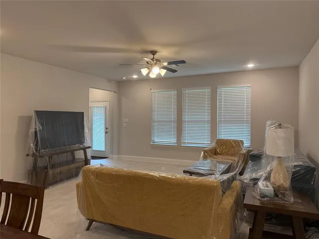 a bedroom with furniture and a ceiling fan