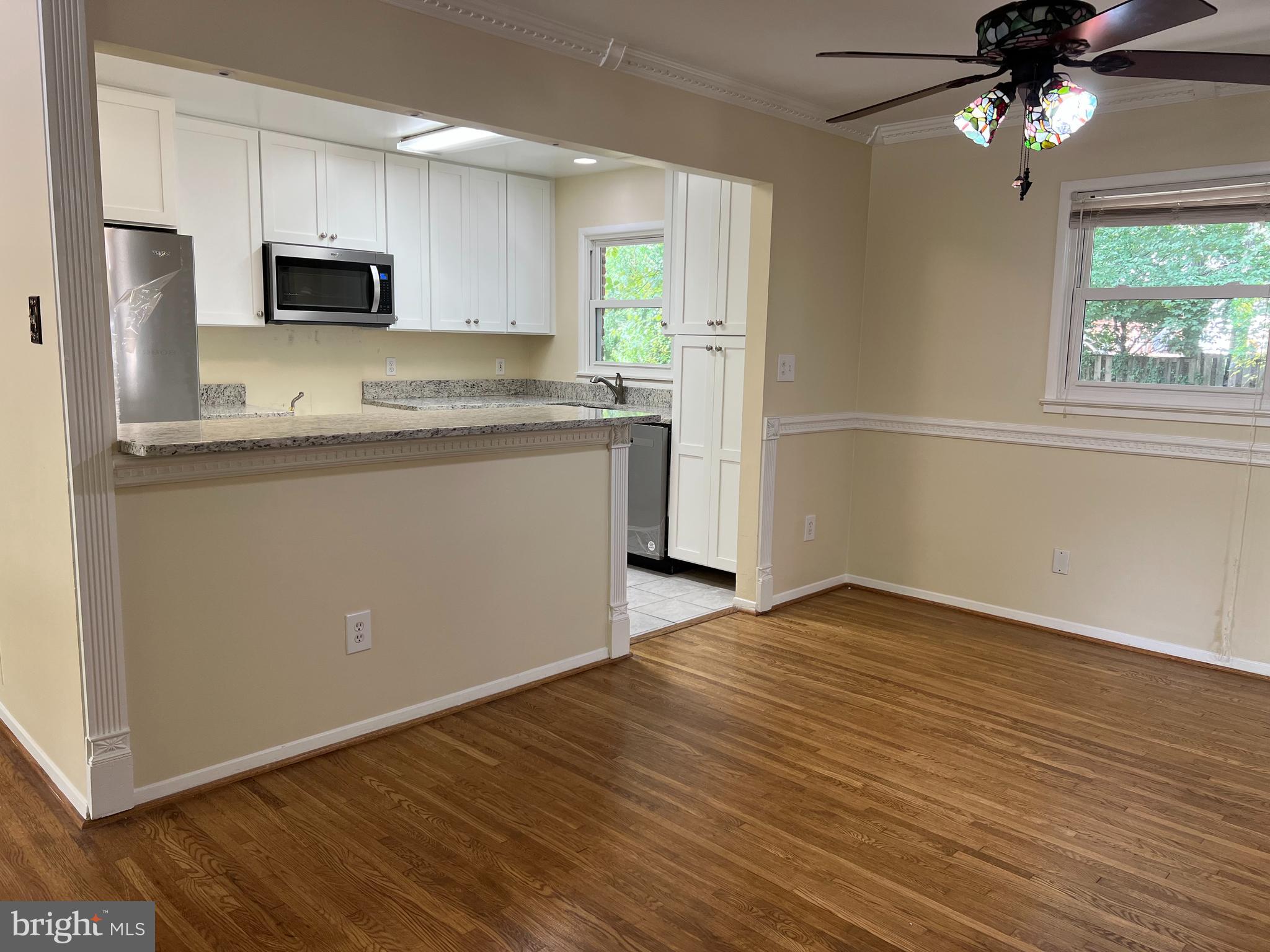 5626 Heming Avenue Springfield, VA 22151 - Photo 12 of 53 a kitchen with granite countertop a stove top oven a sink and dishwasher with wooden floor