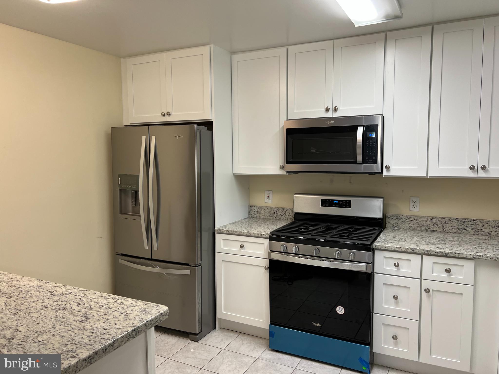 5626 Heming Avenue Springfield, VA 22151 - Photo 13 of 53 a kitchen with granite countertop white cabinets and stainless steel appliances
