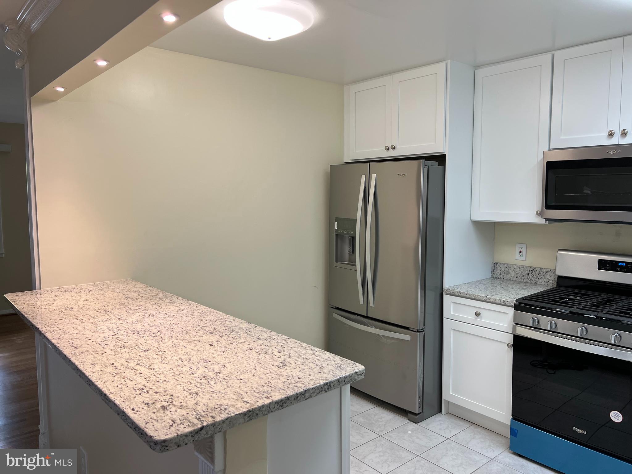 5626 Heming Avenue Springfield, VA 22151 - Photo 14 of 53 a kitchen with stainless steel appliances granite countertop a refrigerator sink and stove