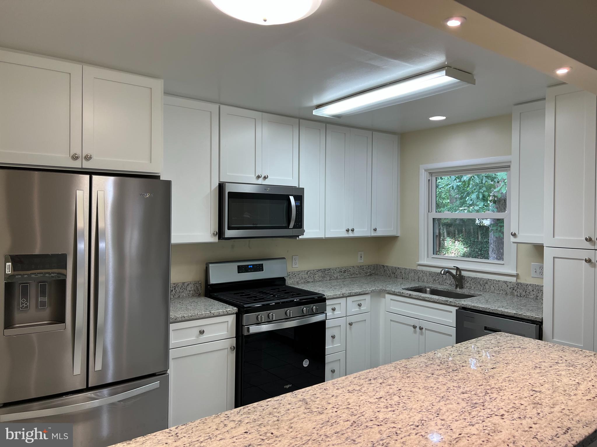 5626 Heming Avenue Springfield, VA 22151 - Photo 16 of 53 a kitchen with granite countertop a refrigerator stove top oven and sink