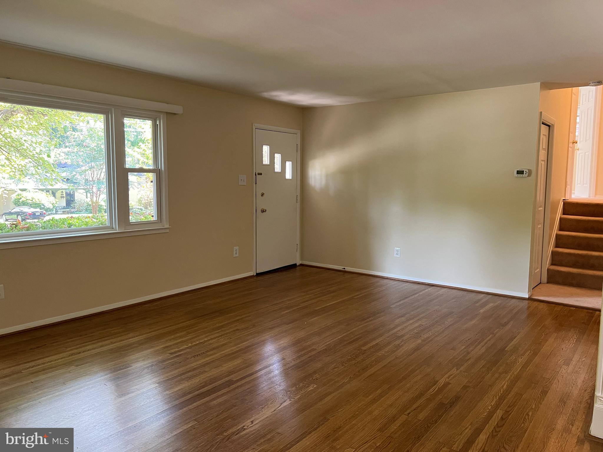 5626 Heming Avenue Springfield, VA 22151 - Photo 3 of 53 a view of an empty room with wooden floor and a window