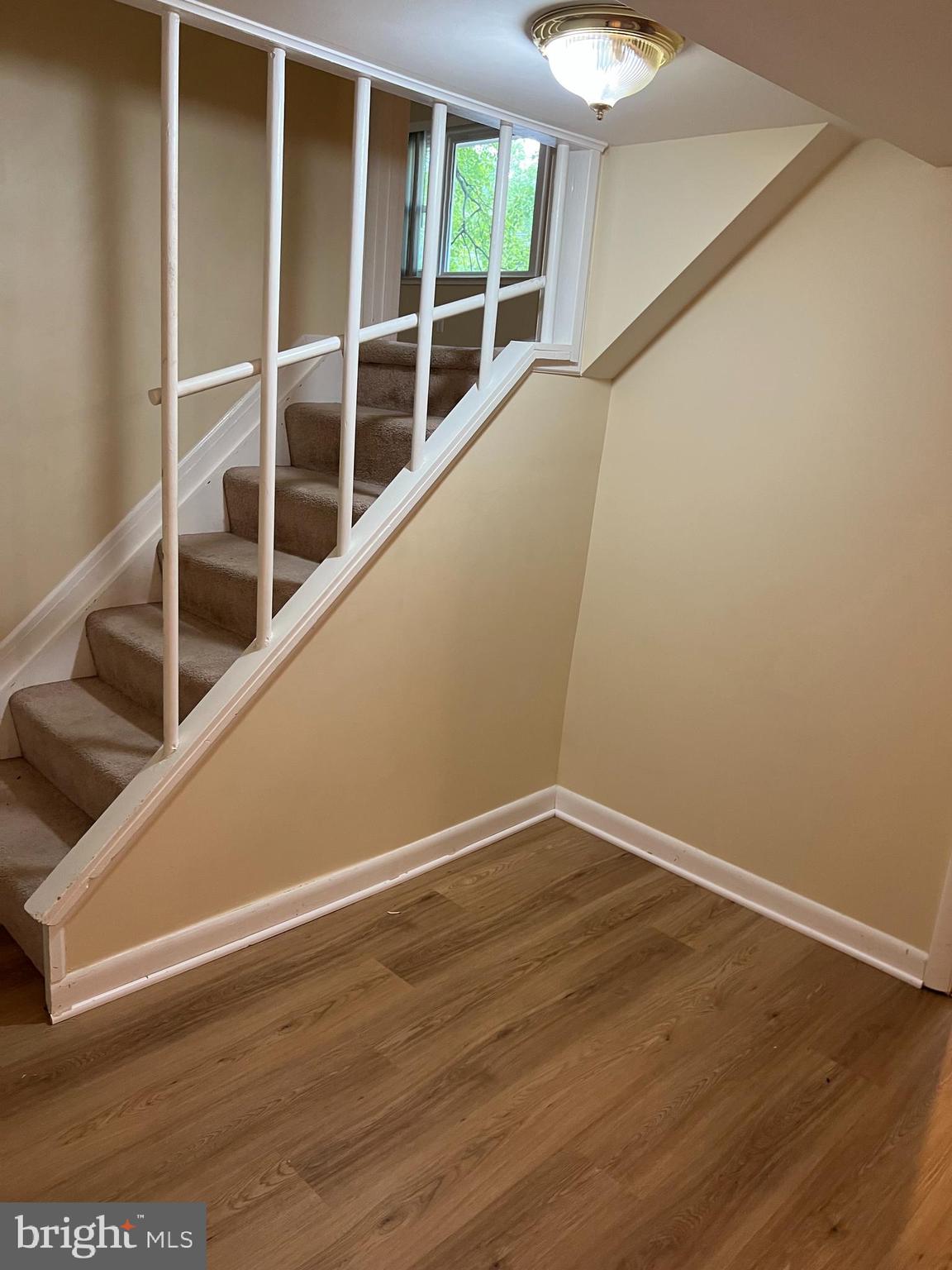 5626 Heming Avenue Springfield, VA 22151 - Photo 38 of 53 a view of an empty room with wooden floor and windows