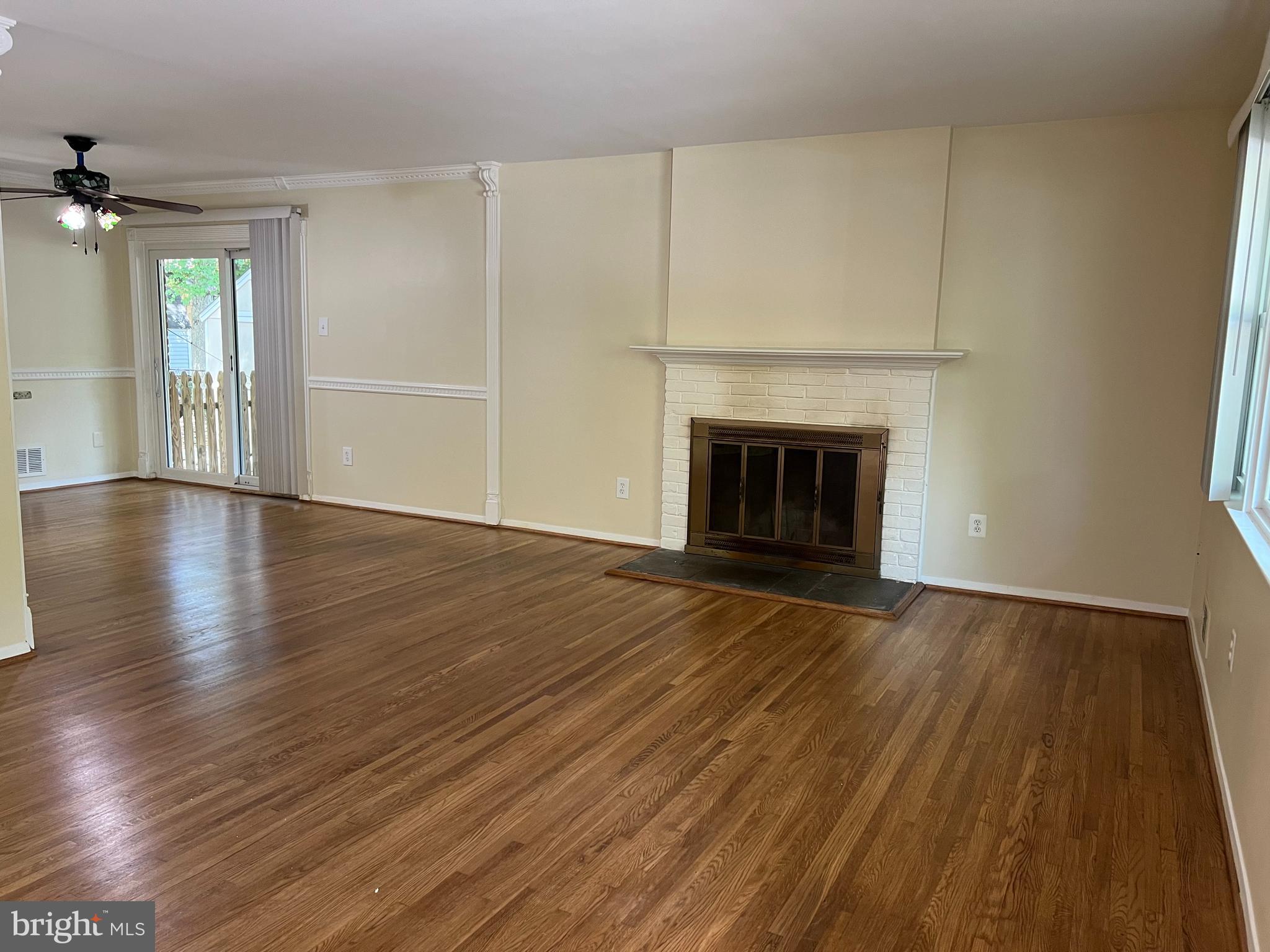 5626 Heming Avenue Springfield, VA 22151 - Photo 4 of 53 an empty room with wooden floor fireplace and windows