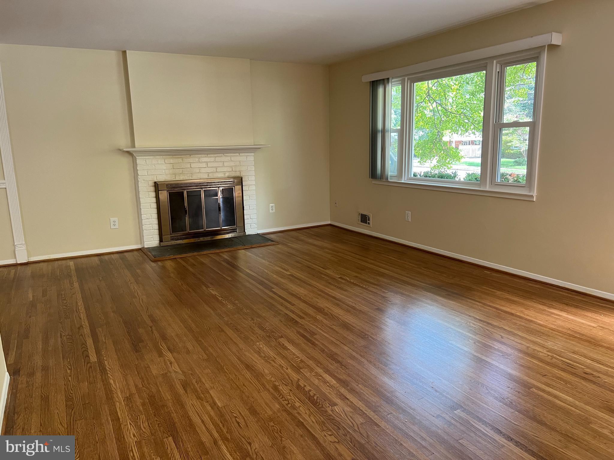 5626 Heming Avenue Springfield, VA 22151 - Photo 7 of 53 a view of an empty room with wooden floor and a window