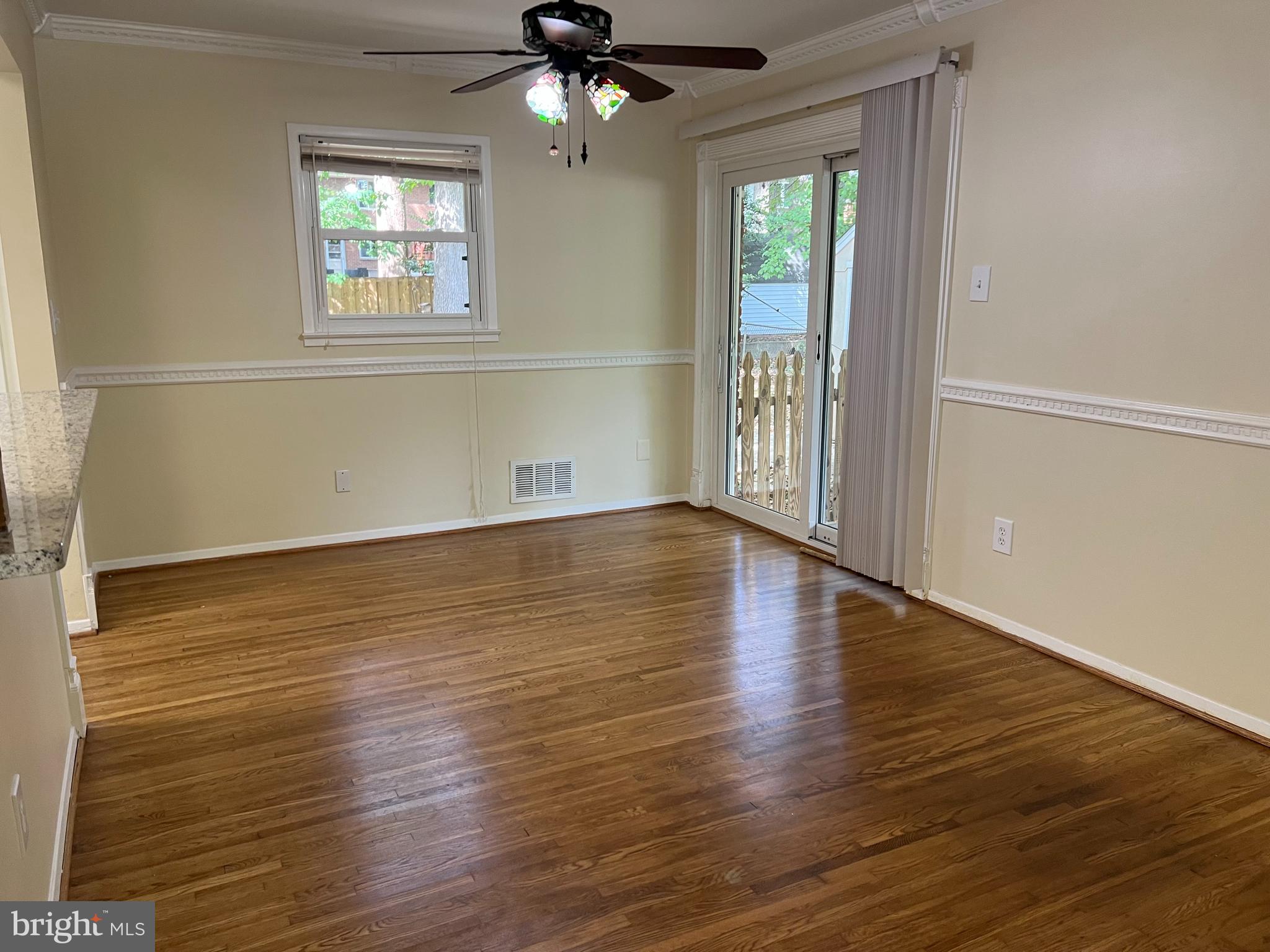 5626 Heming Avenue Springfield, VA 22151 - Photo 9 of 53 an empty room with wooden floor chandelier and windows