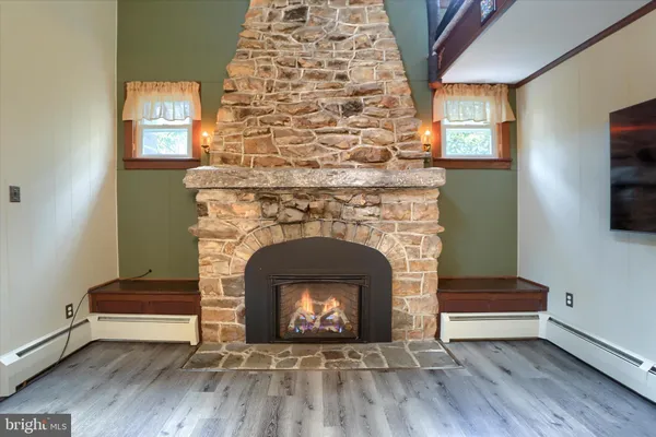 a kitchen with a table chairs and wooden floor
