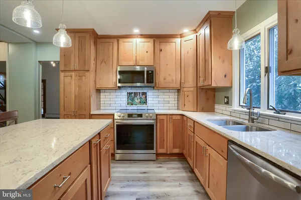 a living room with furniture and a pool table