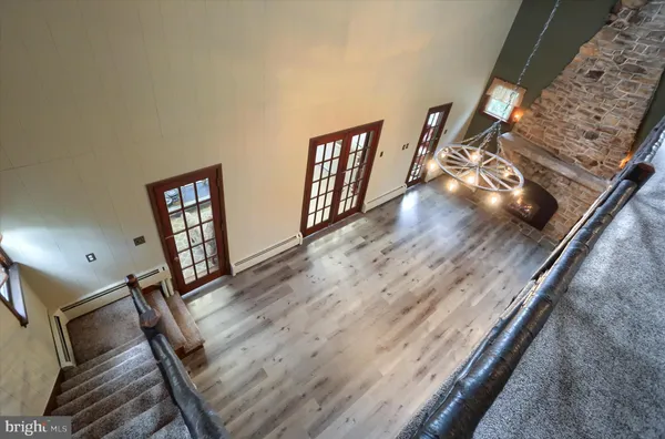 a view of a wooden deck with trees in the background